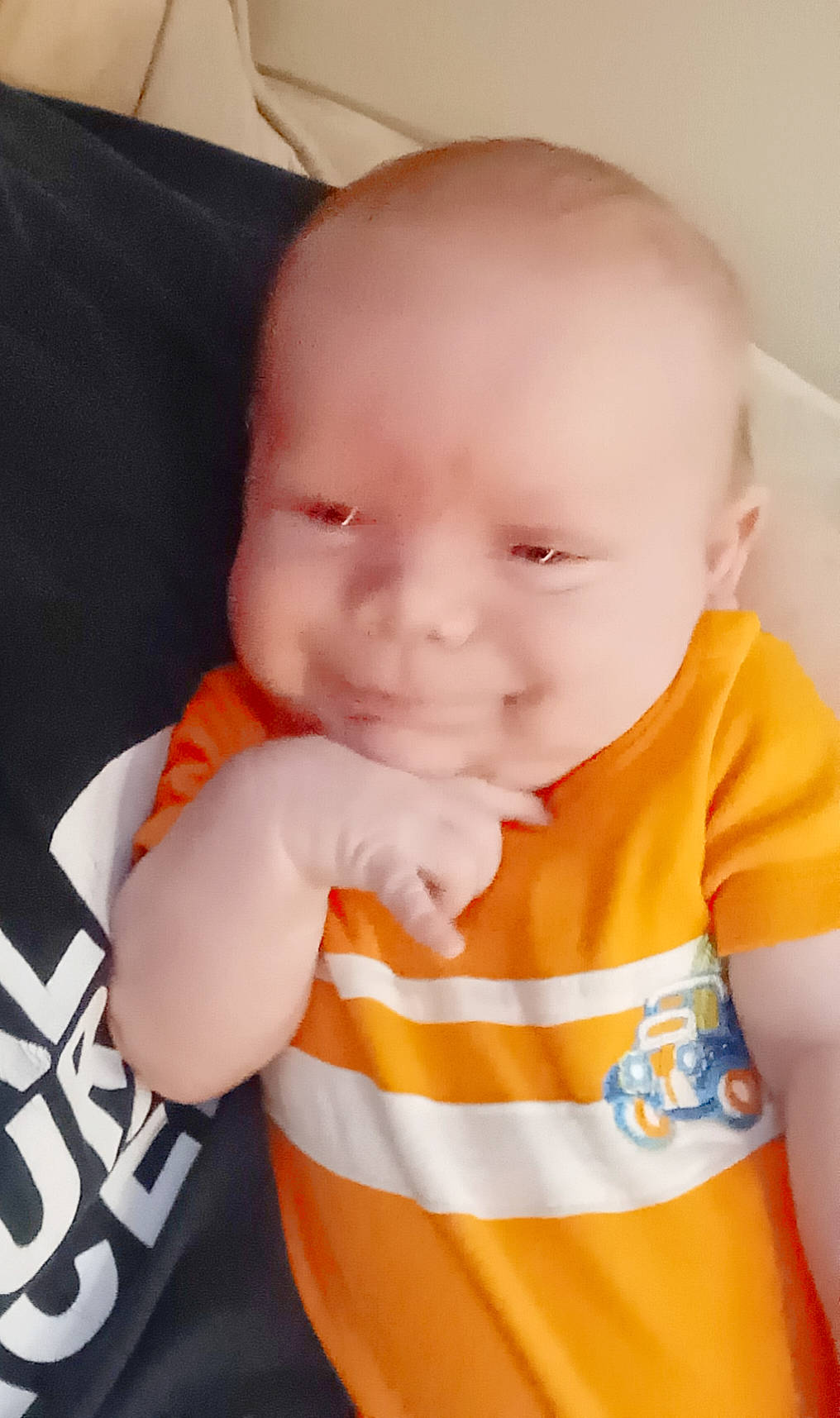 Ethan is registered to the contest to win money with this photo: baby, baby_products, baby_toddler_clothing, cheek, child, chin, eye, eyebrow, face, finger, happy, human_body, neck, nose, orange, person, skin, sleeve, smile, t_shirt