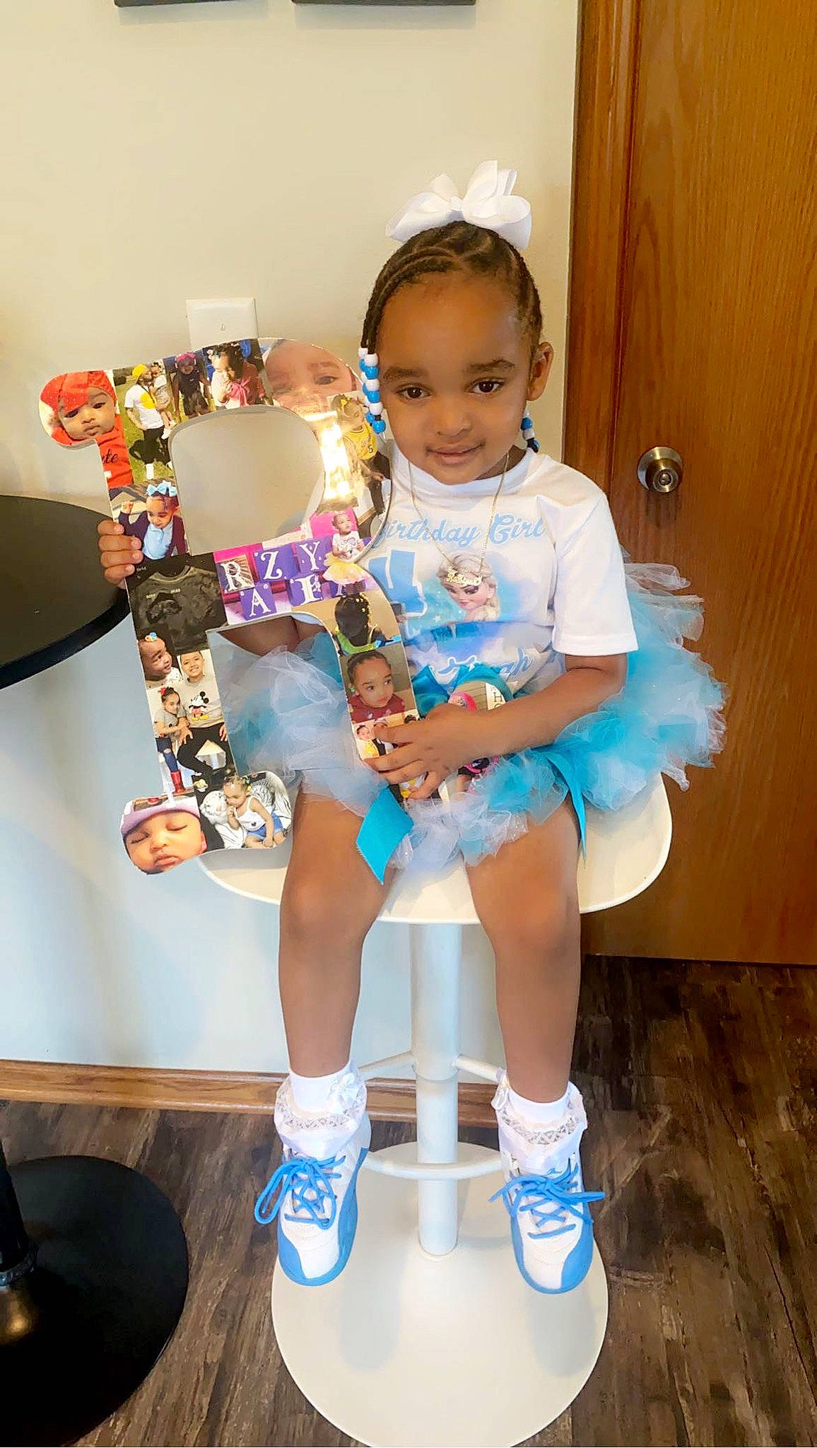 Raziyah is registered to the contest to win money with this photo: baby_toddler_clothing, child, costume, electric_blue, fashion_design, fictional_character, fun, happy, human_leg, jewellery, joy, knee, person, shoe, shorts, sitting, smile, sneakers, sock, t_shirt