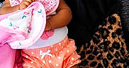 Kai'Lani is registered to the contest to win money with this photo: baby, blanket, child, clothing, couch, cute, face, hand, happy, headband, indoor, infant, leopard_print, pink, polka_dot, portrait, smiling, soft_texture, toddler, white_socks