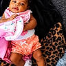 baby, blanket, child, clothing, couch, cute, face, hand, happy, headband, indoor, infant, leopard_print, pink, polka_dot, portrait, smiling, soft_texture, toddler, white_socks
