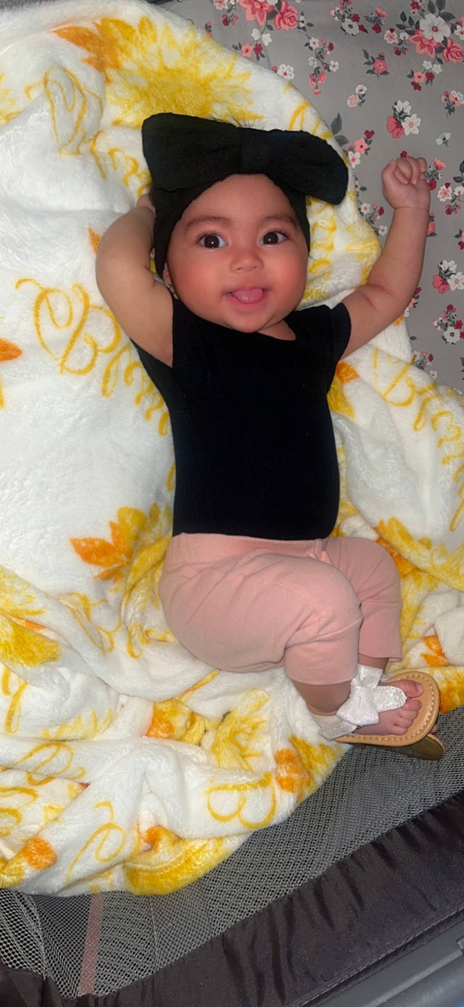 Leylani is registered to the contest to win money with this photo: baby, baby_toddler_clothing, baseball_cap, cap, child, fun, happy, hat, head, headwear, human_body, joy, peach, person, pink, sitting, skin, sleeve, smile, sock