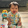 Jackson is registered to the contest to win money with this photo: baby, bright, child, colorful, couch, cute, face, floor, happy, home, indoor, infant, pajamas, person, playful, sitting, smiling, toy, wooden_floor, young_child
