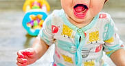 Jackson joined the competition — help win amazing prizes! baby, bright, casual, child, colorful, cute, face, floor, happy, indoor, infant, mouth_open, pajamas, person, playtime, sitting, smiling, tablet, toy, young