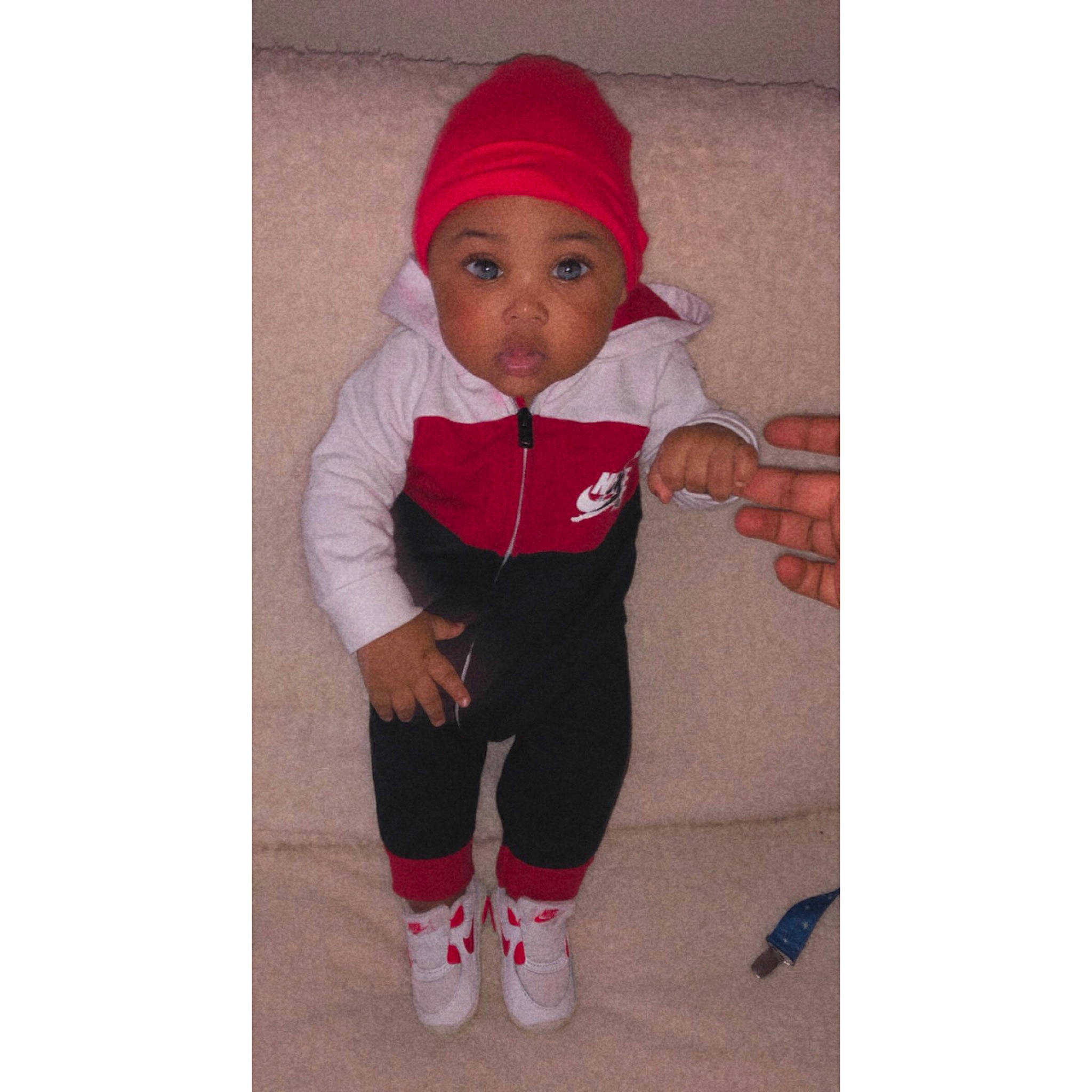 Kyng is registered to the contest to win money with this photo: arm, baby, baby_products, baby_toddler_clothing, cap, child, costume_hat, face, happy, headgear, headwear, human_body, jacket, long_sleeved_t_shirt, magenta, person, pink, sleeve, sneakers, sportswear