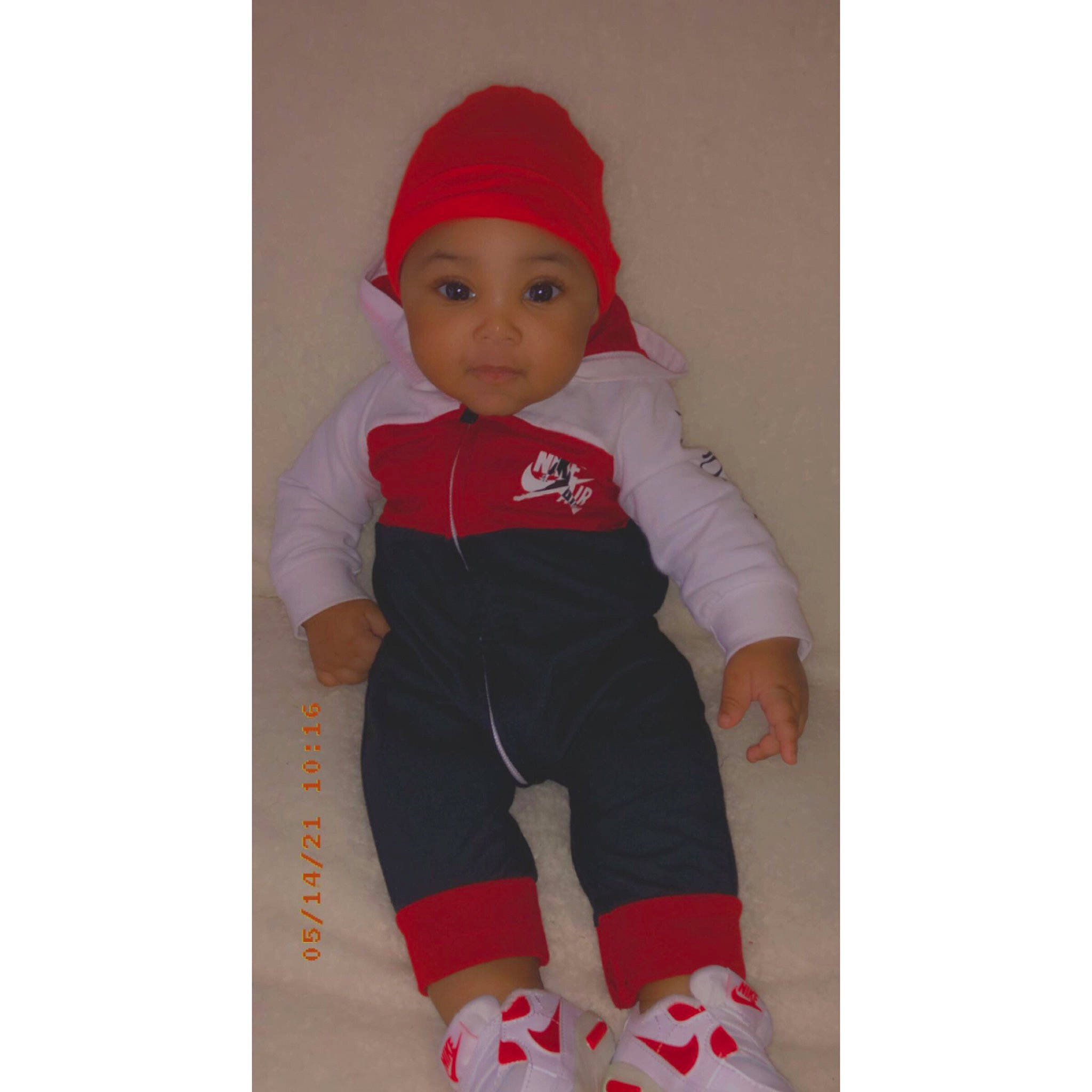 Kyng is registered to the contest to win money with this photo: baby, baby_toddler_clothing, cap, carmine, doll, elbow, electric_blue, face, fashion_accessory, fictional_character, head, headwear, human_body, knee, magenta, pattern, person, sleeve, sock, sportswear