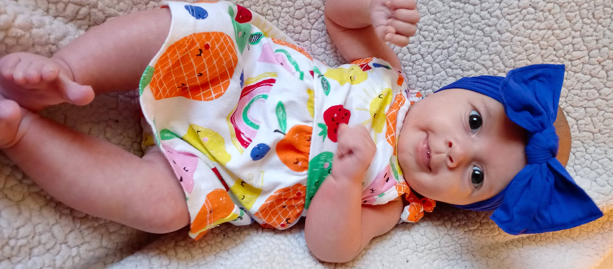 Aponi is registered to the contest to win money with this photo: baby, baby_toddler_clothing, blue, cheek, child, finger, foot, happy, headwear, human_body, human_leg, joint, mouth, nail, nose, orange, organ, person, pink, skin