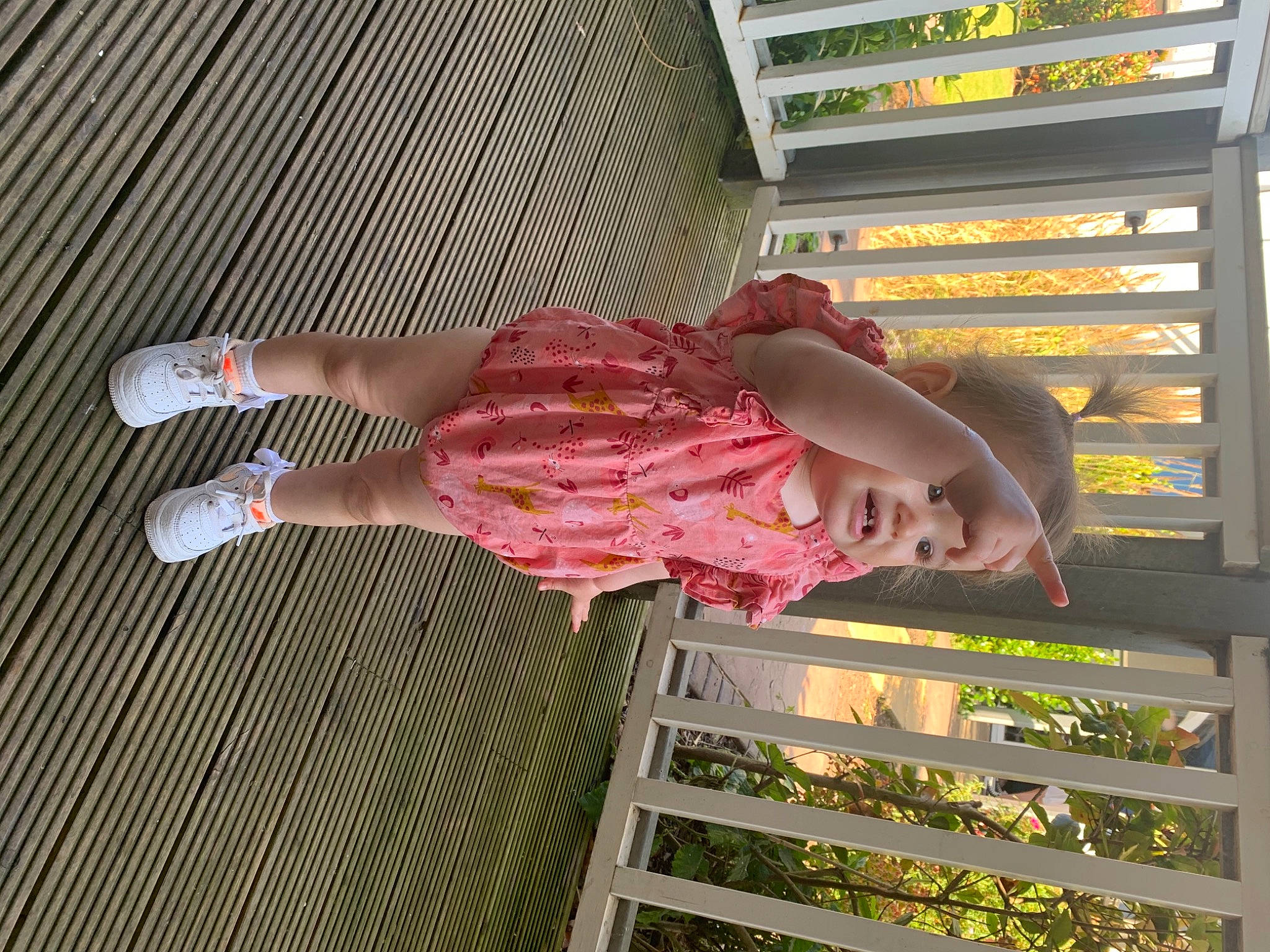 Maya is registered to the contest to win money with this photo: beauty, calf, child, clothing, dress, flesh, flooring, foot, headwear, human_body, human_leg, knee, leg, pattern, person, sandal, shelf, textile, thigh, toddler