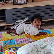 Mireya joined the competition — help win amazing prizes! baby, child, play_mat, toy, pillow, sandal, floor, candle_holder, photo_frame, wooden_shelf, curious, indoors, carpet, colorful, crawling, infant, soft_lighting, home, person, cute