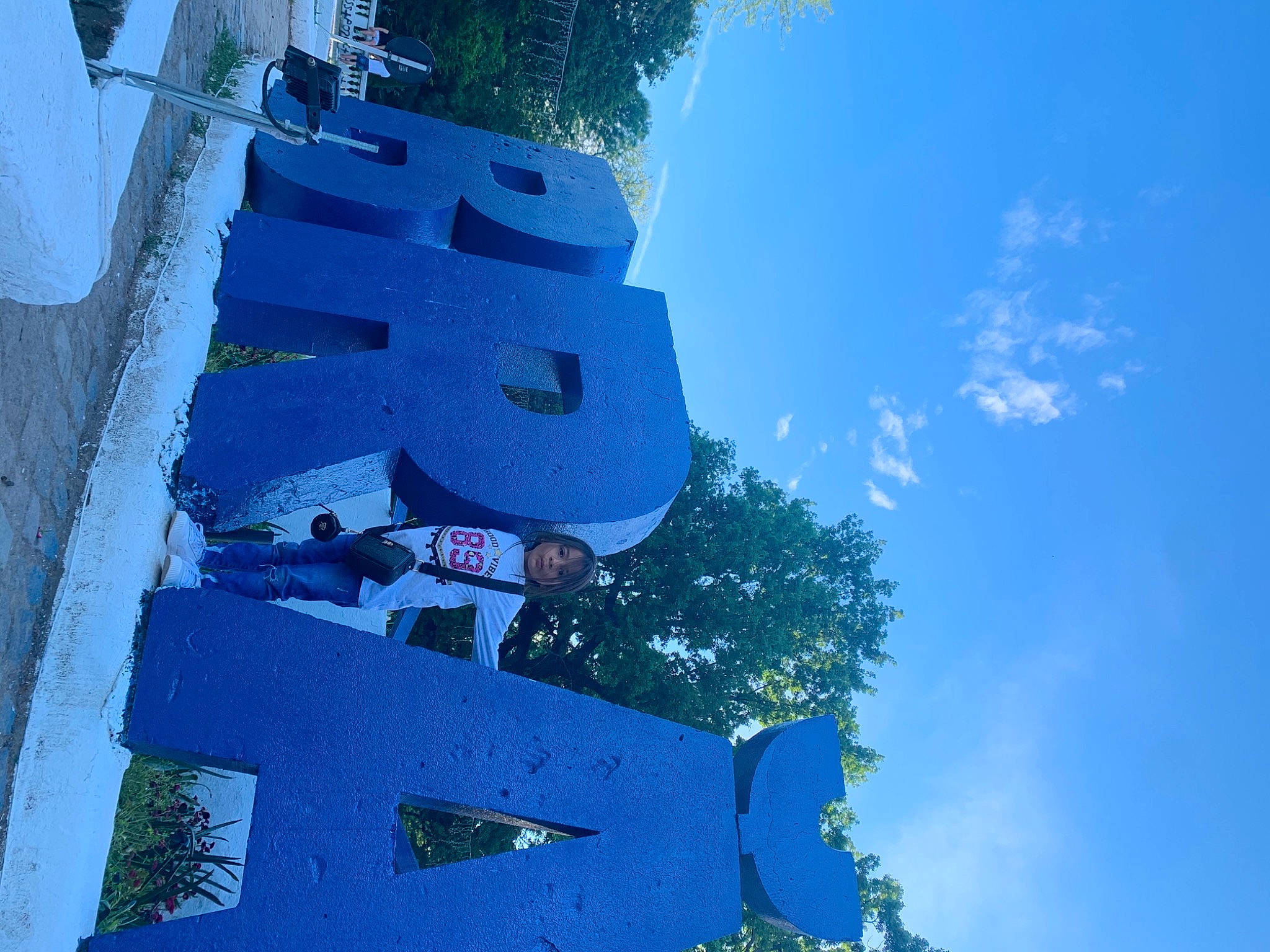 Andreea is registered to the contest to win money with this photo: art, azure, blue, building, city, cloud, electric_blue, facade, font, person, plant, pole, sign, signage, sky, slope, space, tower, tree, urban_design