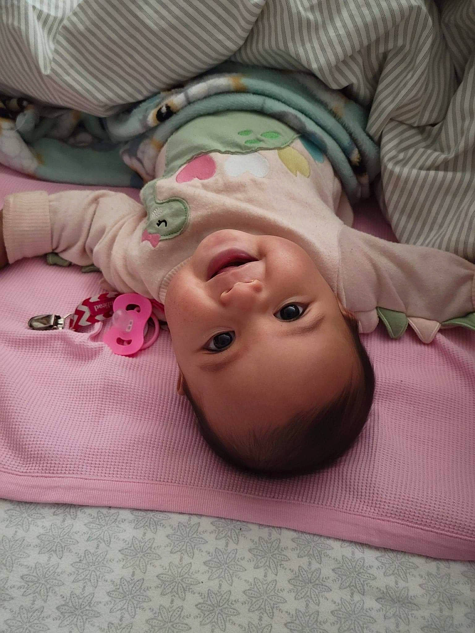 Alexandria is registered to the contest to win money with this photo: baby, baby_products, baby_toddler_clothing, bedding, cheek, child, comfort, eye, eyelash, head, human_body, linens, lip, mouth, nose, person, pink, skin, sleeve, smile