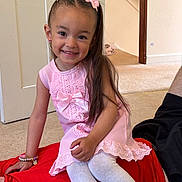 Paisley is registered to the contest to win money with this photo: child, girl, smile, pink_dress, hair_bows, bracelet, white_tights, indoor, carpet, wall, staircase, person, sitting, happy, playful, casual, family, home, portrait, candid