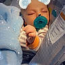 baby, sleeping, pacifier, blue_blanket, striped_clothing, infant, cute_filter, snowflake_ears, hand, closed_eyes, soft_lighting, indoors, cozy, child, portrait, baby_bed, peaceful, adorable, resting, infant_clothing