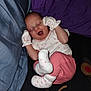 Iris joined the competition — help win amazing prizes! baby, sleeping, yawning, mittens, socks, pink_pants, bed, bedding, purple, blue, black, star_pattern, infant, cute, cozy, lying_down, resting, child, portrait, soft_lighting