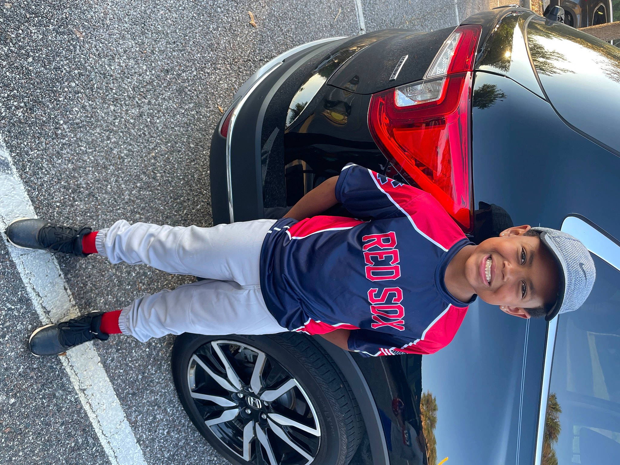 Michael joined the competition — help win amazing prizes! alloy_wheel, automotive_design, automotive_exterior, automotive_lighting, automotive_tire, bumper, car, headwear, hood, hubcap, joy, land_vehicle, motor_vehicle, person, red, rim, rolling, shorts, tire, tread