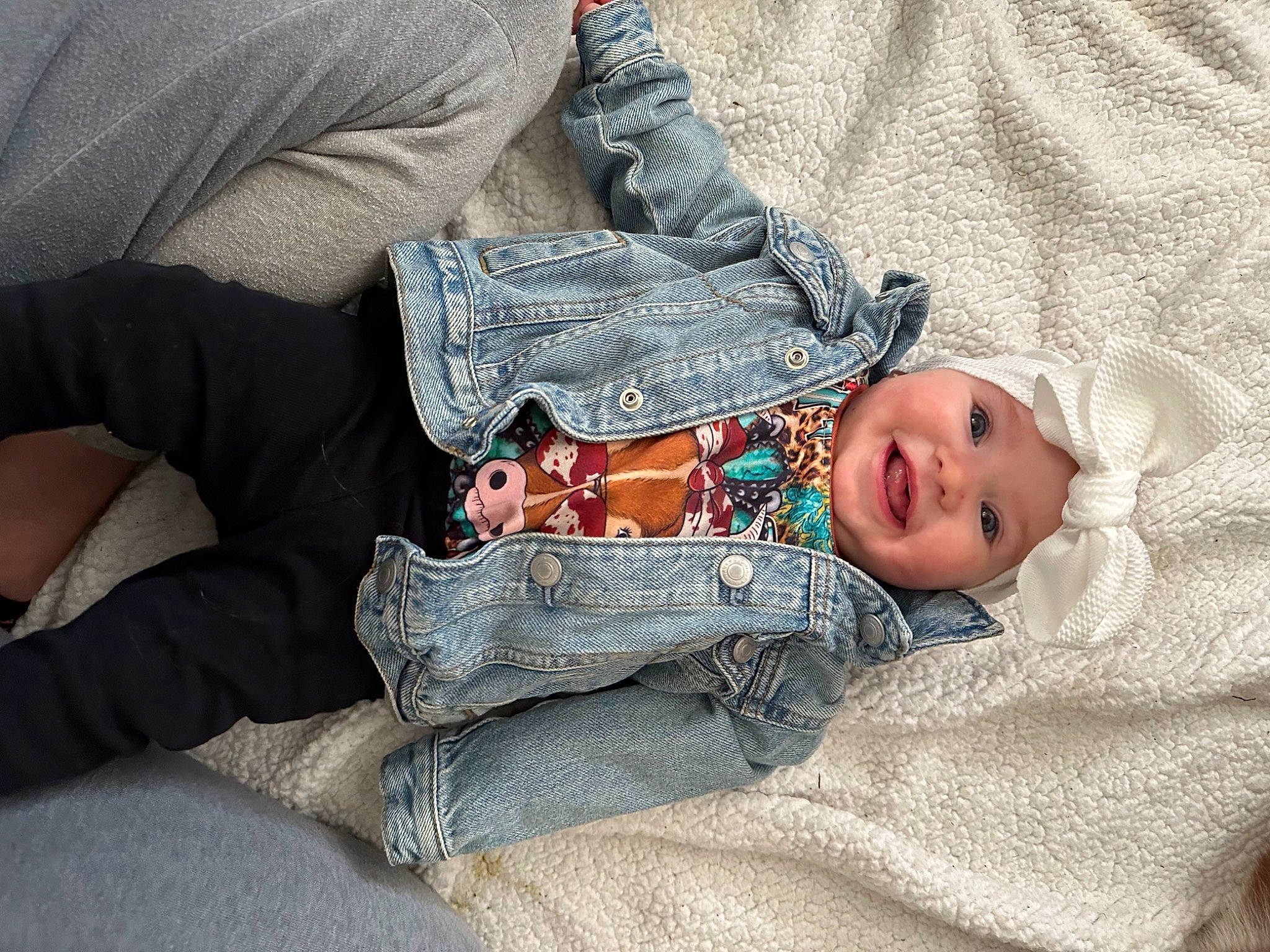 Wrenlee is registered to the contest to win money with this photo: baby, baby_toddler_clothing, child, comfort, denim, elbow, gesture, glasses, headwear, human, human_body, human_leg, joy, lap, linens, pattern, person, sitting, skin, sleeve