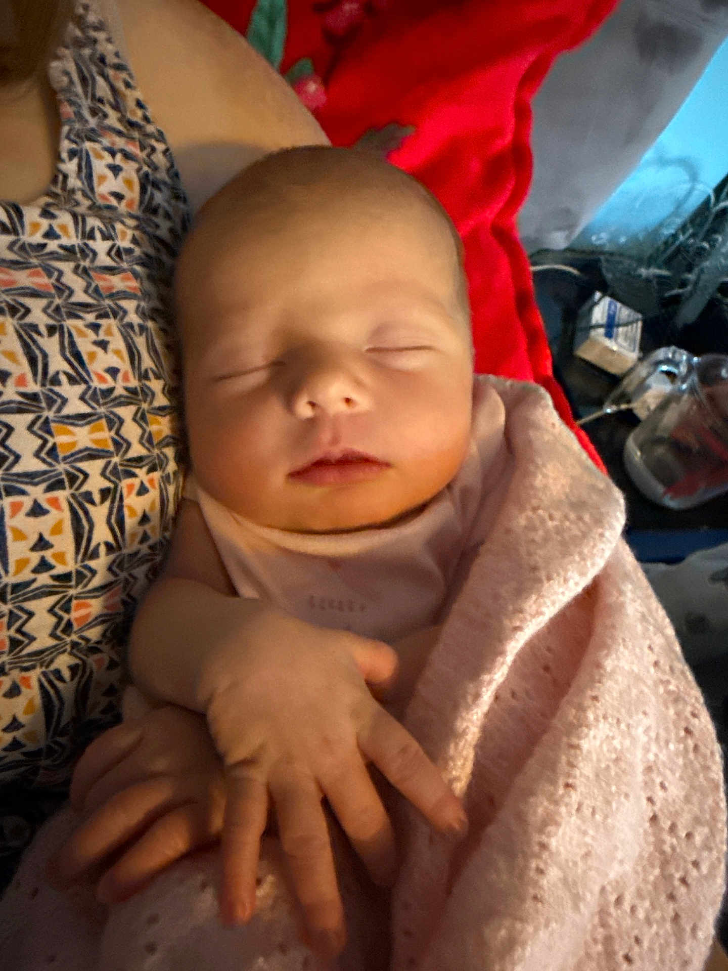 Evelyn joined the competition — help win amazing prizes! baby, sleeping, blanket, hand, person, patterned_clothing, indoor, closeup, peaceful, child, infant, resting, soft_light, pink, human, portrait, tender, cozy, newborn, holding
