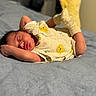 baby, newborn, sleeping, onesie, yellow_bear_prints, socks, blanket, bed, infant, cozy, cute, peaceful, soft, resting, portrait, indoors, child, tiny, relaxed, sleep