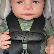 Odinn is registered to the contest to win money with this photo: baby, child, car_seat, safety_harness, camouflage_clothing, blue_pants, infant, serious_expression, spiky_hair, hands, seatbelt, straps, car_safety, portrait, indoors, person, cute, small_hands, closeup, young_child