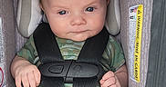 Odinn is registered to the contest to win money with this photo: baby, infant, car_seat, child, face, clothing, straps, socks, blue_pants, camouflage, headrest, sitting, safety, indoor, cute, portrait, young_child, seat_belt, infant_carrier, baby_girl_or_boy