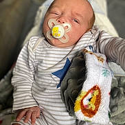 Enzo-John joined the competition — help win amazing prizes! baby, pacifier, blanket, onesie, striped_clothing, blue_star, hand, infant, sleepy, face, portrait, cozy, soft_texture, child, newborn, cute, indoors, resting, human, comfort