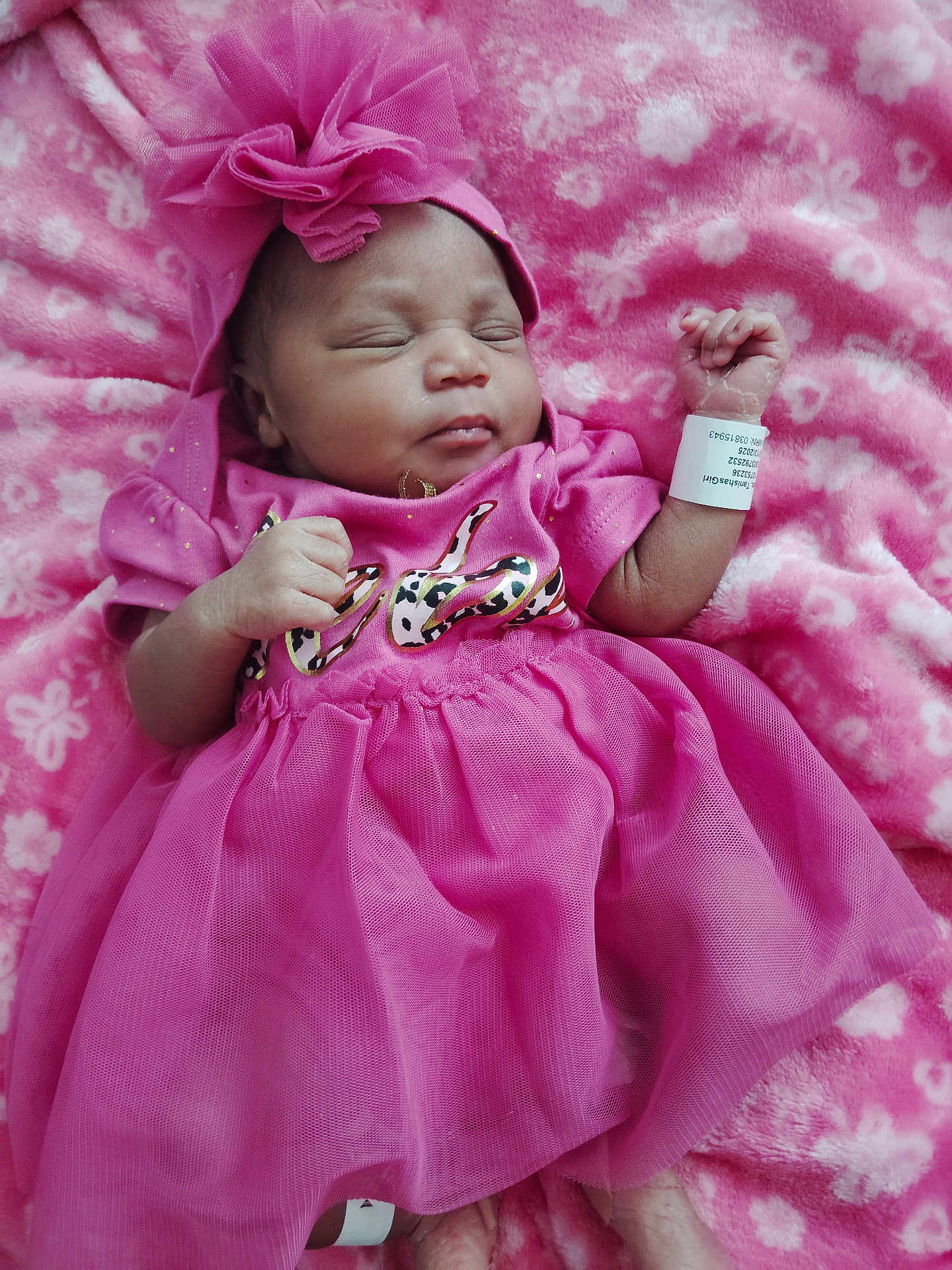 Sevyn joined the competition — help win amazing prizes! baby, newborn, pink_dress, headband, blanket, sleeping, infant, hospital_band, soft_texture, cute, child, portrait, tulle_skirt, peaceful, resting, hand, foot, indoors, closeup, adorable