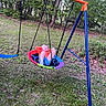 child, swing, playground, outdoor, grass, trees, greenery, relaxing, leisure, colorful, clothing, footwear, nature, summer, recreation, person, play, backyard, metal_frame, casual