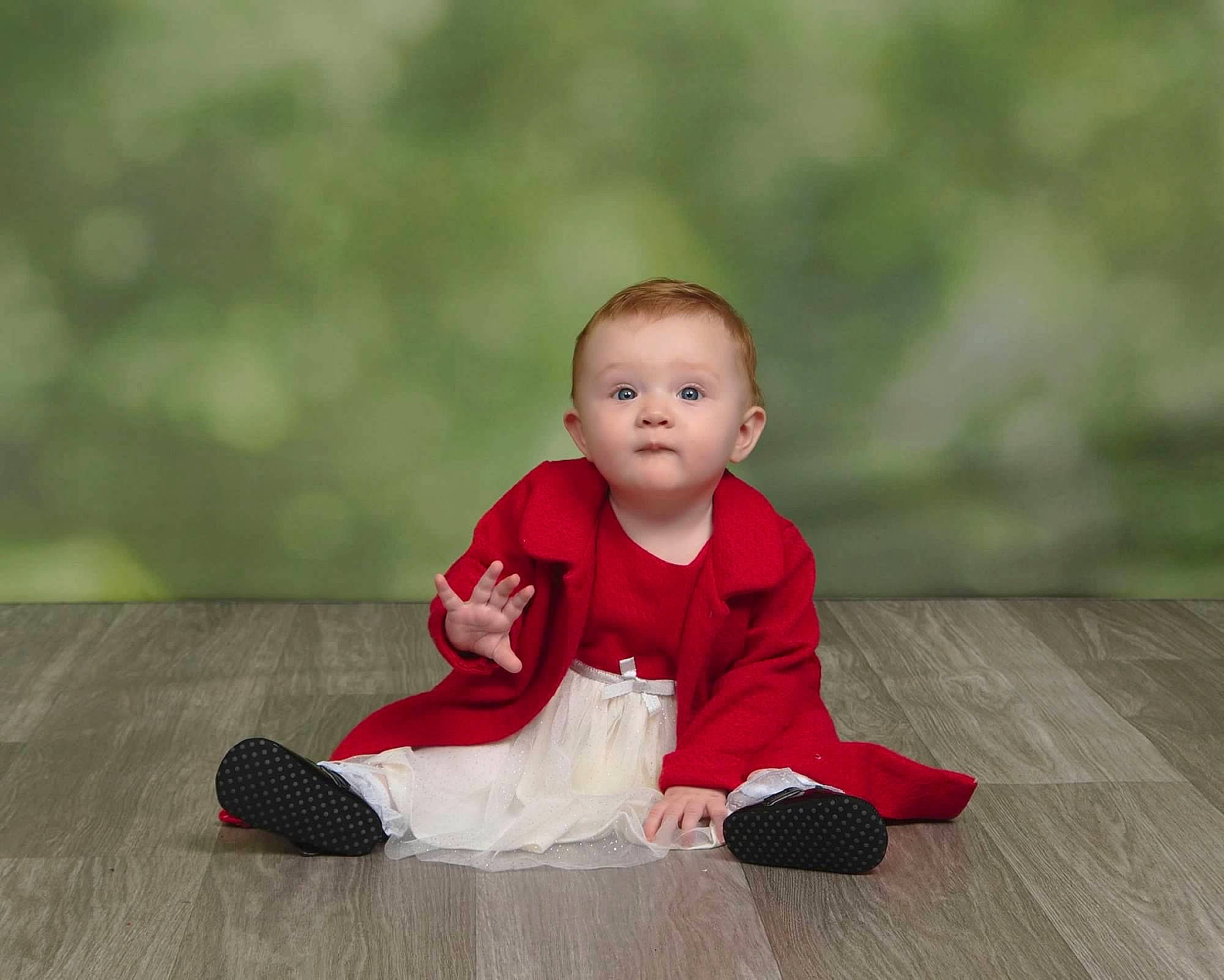 Evelyn is registered to the contest to win money with this photo: baby, baby_toddler_clothing, carmine, child, floor, flooring, fun, grass, happy, hardwood, human_leg, laminate_flooring, pattern, people_in_nature, person, sitting, sleeve, toddler, tree, wood