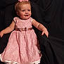 toddler, girl, pink_dress, headband, smile, child, portrait, happy, seated, lace, sparkle, indoor, cute, baby, fashion, person, cloth, background, black_fabric, chubby_cheeks