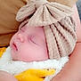 accessories, baby, blanket, bodypart, bonnet, cap, clothing, couch, face, finger, furniture, hand, hat, head, newborn, person, photography, portrait, sleeping, towel