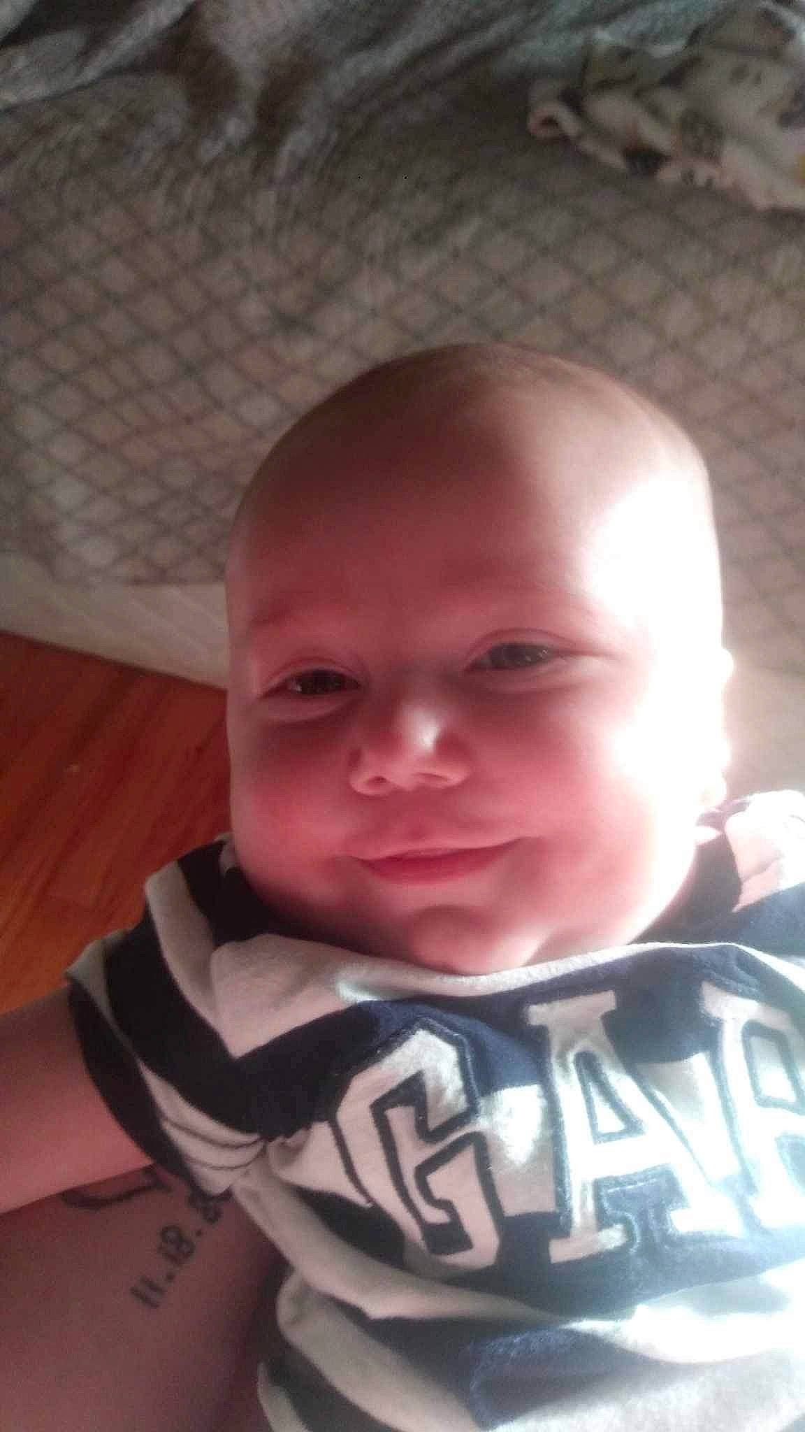 Austin is registered to the contest to win money with this photo: baby, baby_toddler_clothing, cheek, comfort, eye, eyebrow, finger, forehead, happy, head, human_body, iris, jaw, lip, mouth, neck, nose, person, skin, sleeve