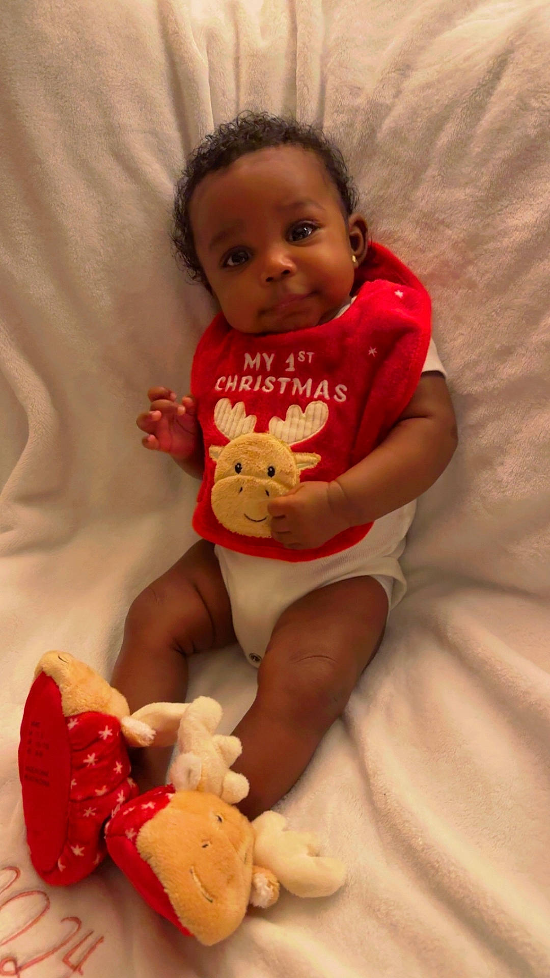 baby, bodypart, clothing, couch, cushion, face, finger, furniture, glove, hand, happy, head, homedecor, indoors, person, photography, portrait, sitting, smile, toy