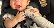 Athena joined the competition — help win amazing prizes! baby, car, car_seat, child, child_safety, closeup, curly_hair, cute, expression, face, happy, indoors, infant, safety, seatbelt, skin, small_hands, smiling, toy, white_clothing