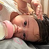 Athena joined the competition — help win amazing prizes! baby, bottle, milk, infant, cute, closeup, face, hand, lying_down, pink, drink, young_child, curly_hair, soft_light, indoors, sleepwear, expression, skin, person, feeding