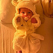 Gracie-May is registered to the contest to win money with this photo: baby, bed, blanket, child, comfort, cozy, cute, face, feet, fluffy, hands, indoors, infant, newborn, pacifier, pale, robe, sleepwear, soft, warm_light