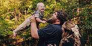 Dallas Kash is registered to the contest to win money with this photo: family, child, toddler, man, woman, outdoor, park, greenery, smile, happy, beard, casual_clothing, hair_bow, nature, trees, grass, playful, joy, parenthood, affection