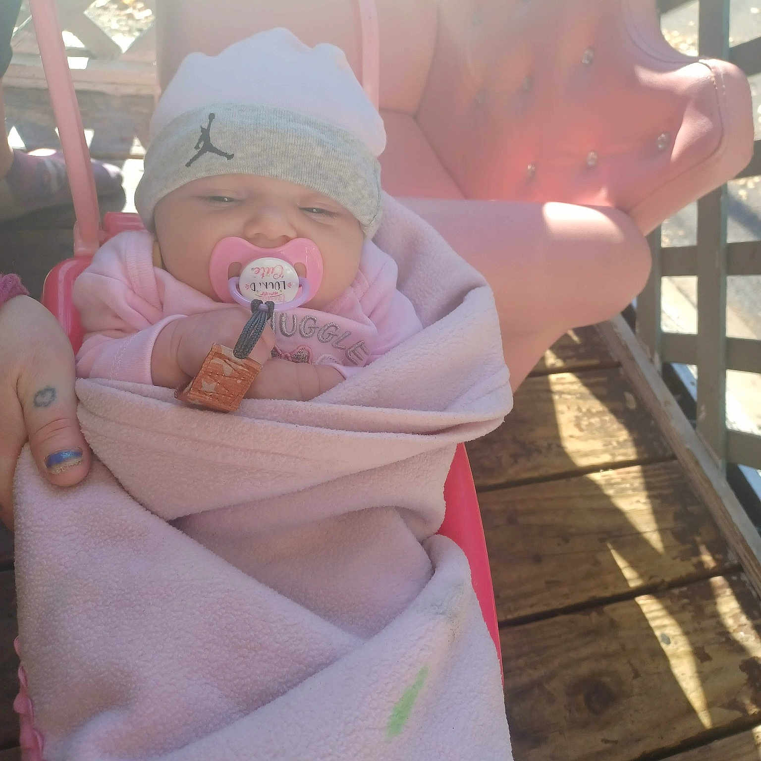 Braylyn joined the competition — help win amazing prizes! baby, baby_products, baby_toddler_clothing, child, comfort, fence, fun, gesture, happy, hat, nail, peach, pink, sitting, skin, sun_hat, thumb, toddler, vacation, wood