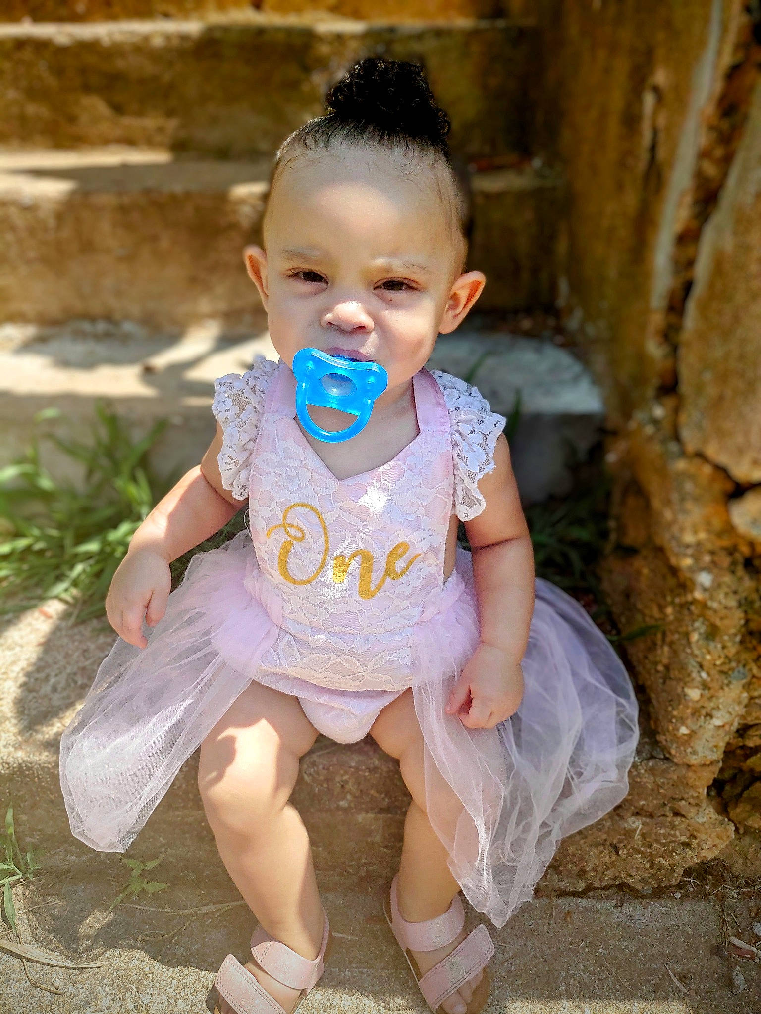 Sariyah is registered to the contest to win money with this photo: baby, baby_toddler_clothing, cheek, dress, face, fun, grass, hair, happy, iris, lip, neck, outerwear, person, pink, sitting, skin, sleeve, smile, t_shirt