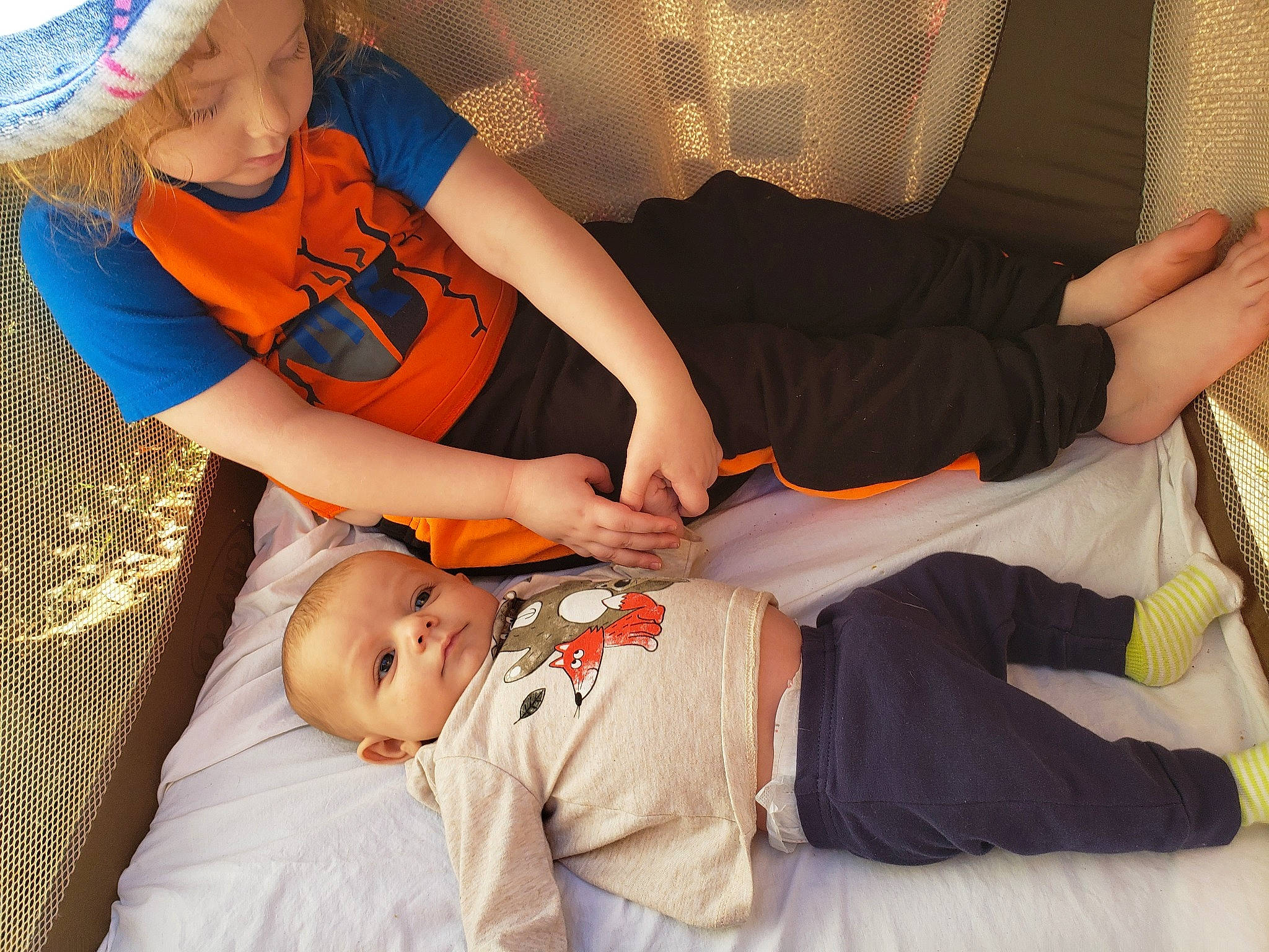 Jack is registered to the contest to win money with this photo: arm, baby, baby_products, baby_toddler_clothing, child, comfort, curtain, elbow, eye, finger, foot, hand, human_body, lap, nose, person, playing_with_kids, sock, sun_hat, toddler