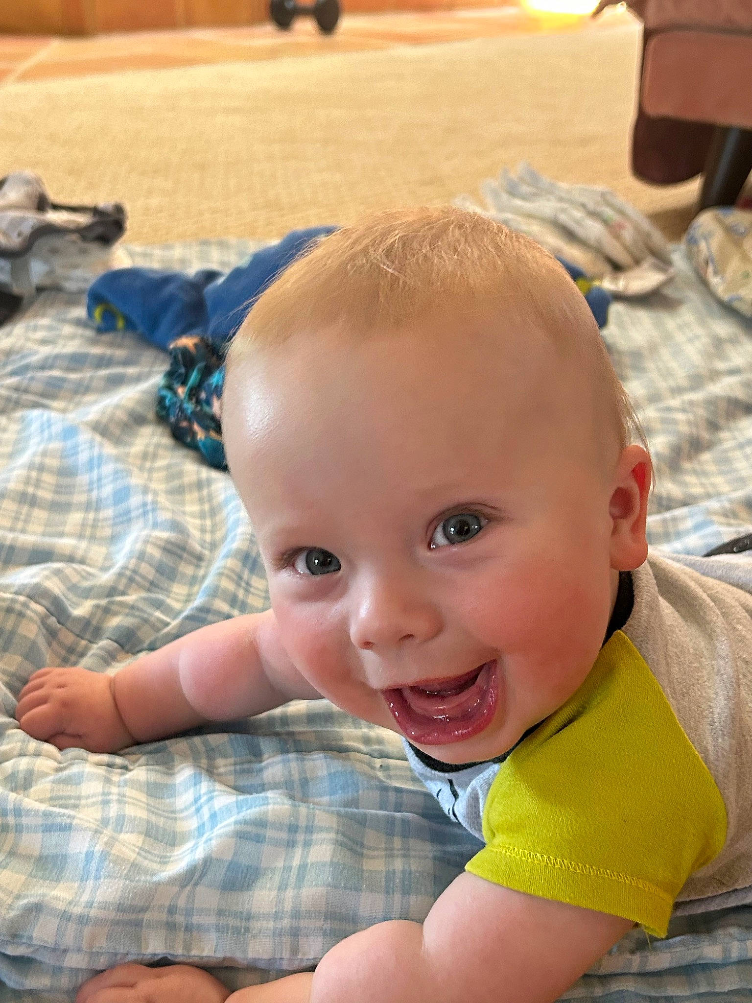 Julian is registered to the contest to win money with this photo: baby, baby_toddler_clothing, cheek, child, comfort, eye, face, flooring, fun, grass, happy, joy, mouth, nose, pattern, person, plaid, skin, smile, tartan