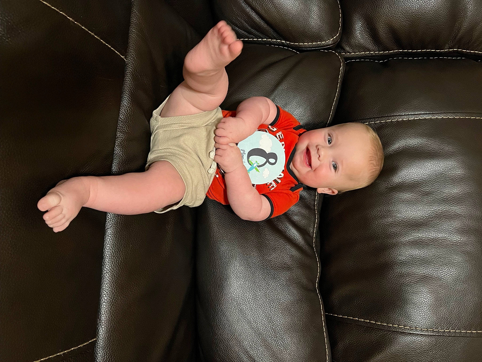 Julian is registered to the contest to win money with this photo: arm, baby, baby_products, baby_toddler_clothing, chair, child, comfort, finger, flash_photography, fun, gesture, hand, joy, leg, nail, pattern, person, sitting, sleeve, thumb