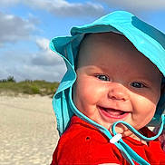 Josephine joined the competition — help win amazing prizes! baby, beach, blue_eyes, child, clouds, cute, daylight, happy, hat, headwear, infant, lighthouse, outdoor, portrait, red_clothing, sand, sky, smiling, sun_hat, vacation