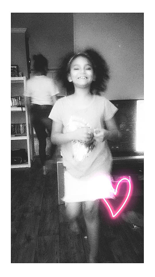 Kamille is registered to the contest to win money with this photo: abdomen, black_and_white, chest, child, event, flash_photography, hairstyle, happy, human, joy, monochrome, monochrome_photography, person, room, shoulder, smile, standing, style, toddler, trunk