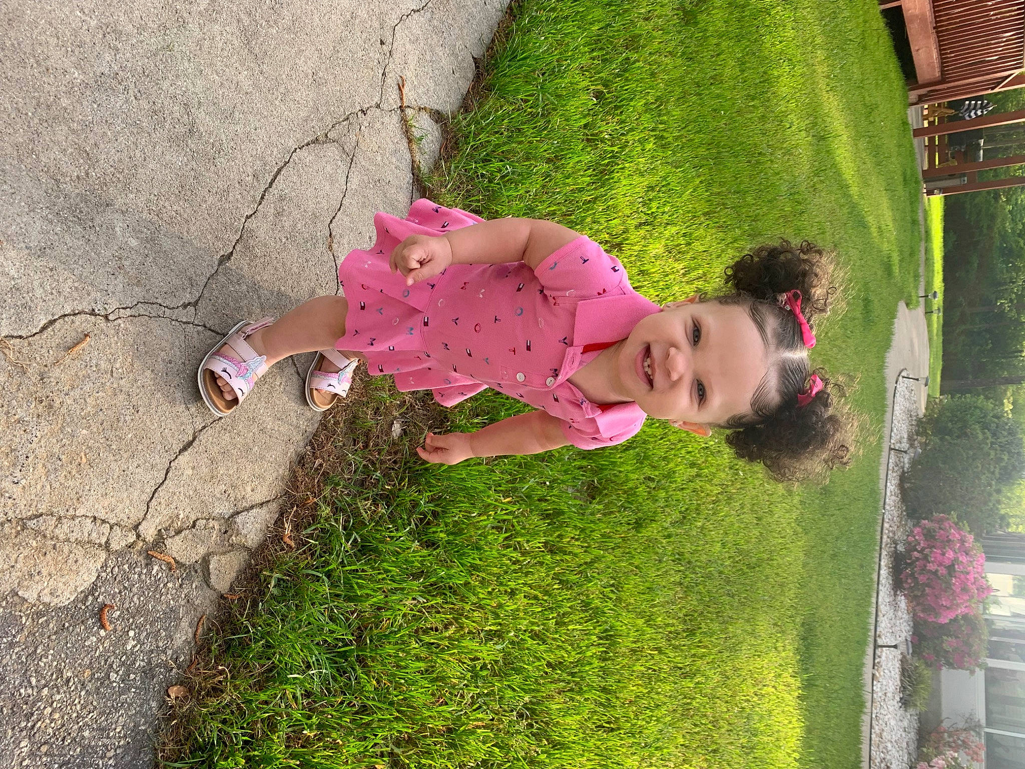 Mehlani is registered to the contest to win money with this photo: baby_toddler_clothing, child, fun, garden, grass, green, groundcover, happy, leisure, magenta, people_in_nature, person, pink, plant, play, recreation, sandal, shrub, sidewalk, toddler