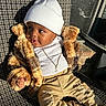 Jahmarii is registered to the contest to win money with this photo: baby, child, hat, beanie, fur_jacket, ripped_pants, boots, necklace, chair, sunlight, pattern, outdoor, cute, fashion, portrait, smile, happy, toddler, clothing, warm