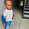 Jahmarii is registered to the contest to win money with this photo: toddler, child, smile, denim_jacket, jeans, walking, hallway, staircase, concrete_floor, doorway, light, shoe, person, casual_clothing, happy, young_child, indoor, portrait, cute, fashion
