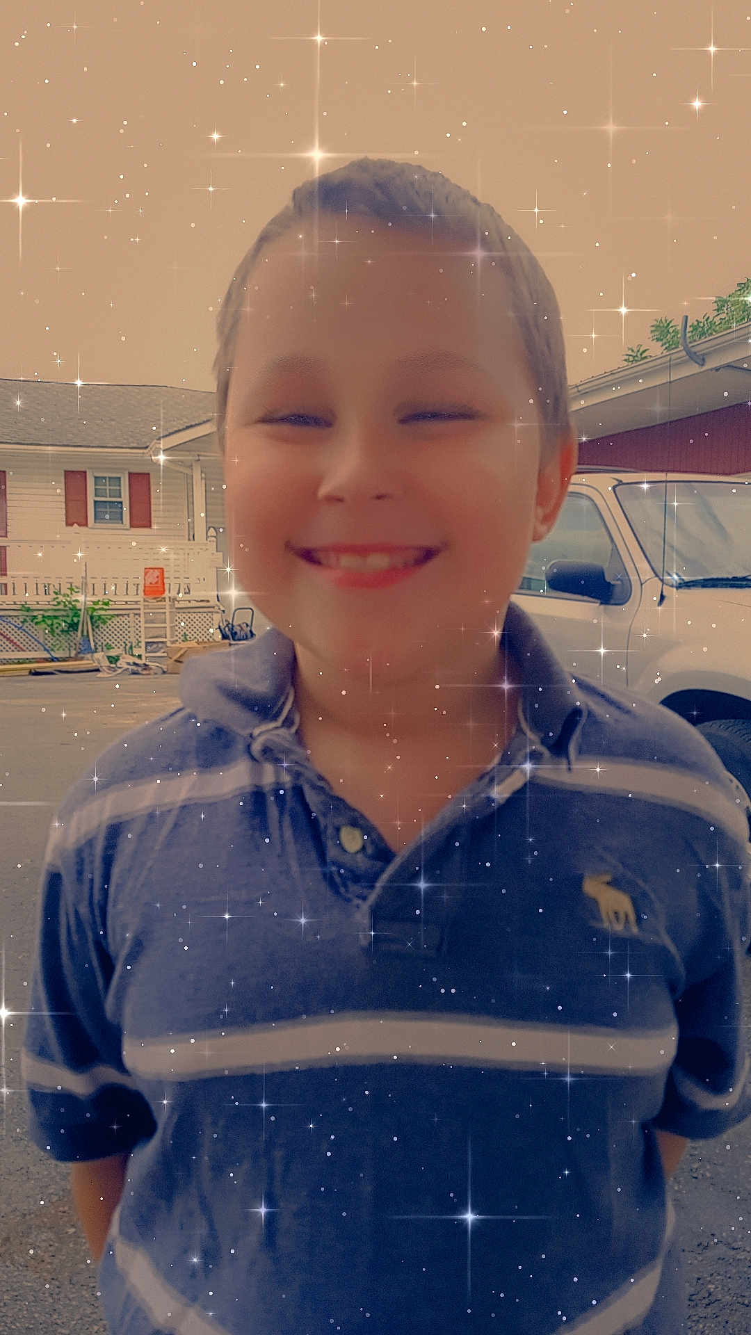 Tyler Jr. joined the competition — help win amazing prizes! child, boy, smiling, outdoor, driveway, sparkle_effect, star_effect, shirt, polo_shirt, short_hair, casual_clothing, vehicle, car, building, window, fence, daytime, happy, portrait, person