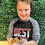 Tyler Jr. joined the competition — help win amazing prizes! child, boy, chick, gloves, greenery, plant_wall, smile, casual_clothing, orange_pants, sitting, animal, pet, cute, portrait, indoor, young, happy, hands, holding, nature