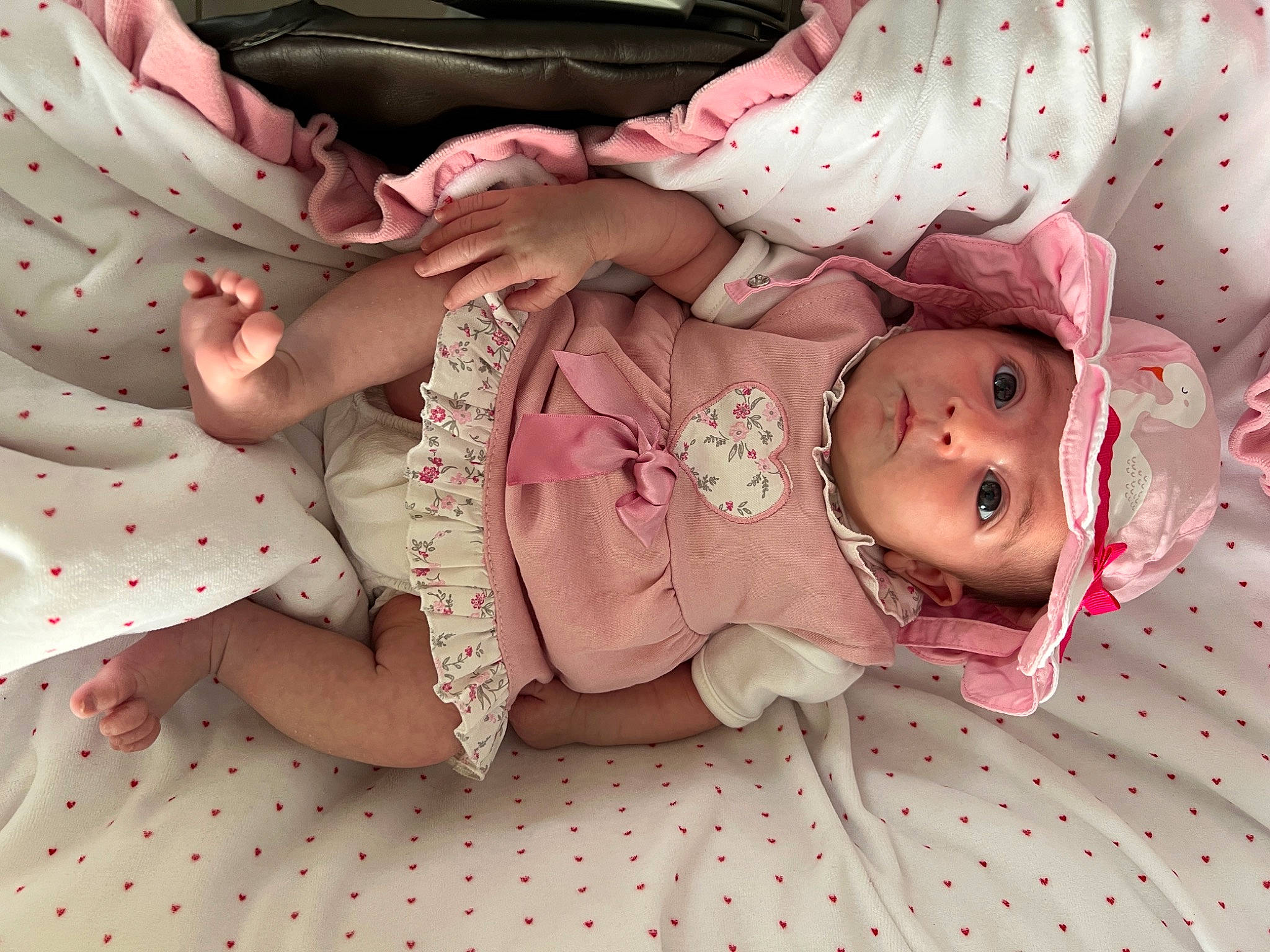Chloé participe au concours pour gagner de l'argent avec cette photo : arm, baby, baby_products, baby_toddler_clothing, cheek, child, doll, dress, fashion_accessory, head, headwear, human_body, pattern, peach, person, pink, skin, sleeve, textile, toddler