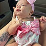 baby, infant, pink_bow, polka_dot, headband, tattoo, car_interior, child, cute, clothing, person, holding, seat, skin, arm, legs, cute_outfit, pink, white, portrait