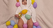 Aidalenyz is registered to the contest to win money with this photo: baby, blanket, bunny_costume, child, colorful, cute, easter_eggs, festive, headwear, holiday_theme, indoors, infant, legs, lying_down, plastic_eggs, portrait, small_feet, soft_texture, toy, white_clothing